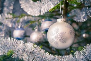 Christmas-tree decoration bauble on decorated Christmas tree bac