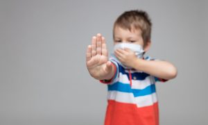 Young child wearing a respiratory mask as a prevention against the Coronavirus Covid-19