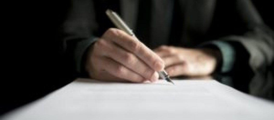 Closeup of lawyer or executive signing a contract