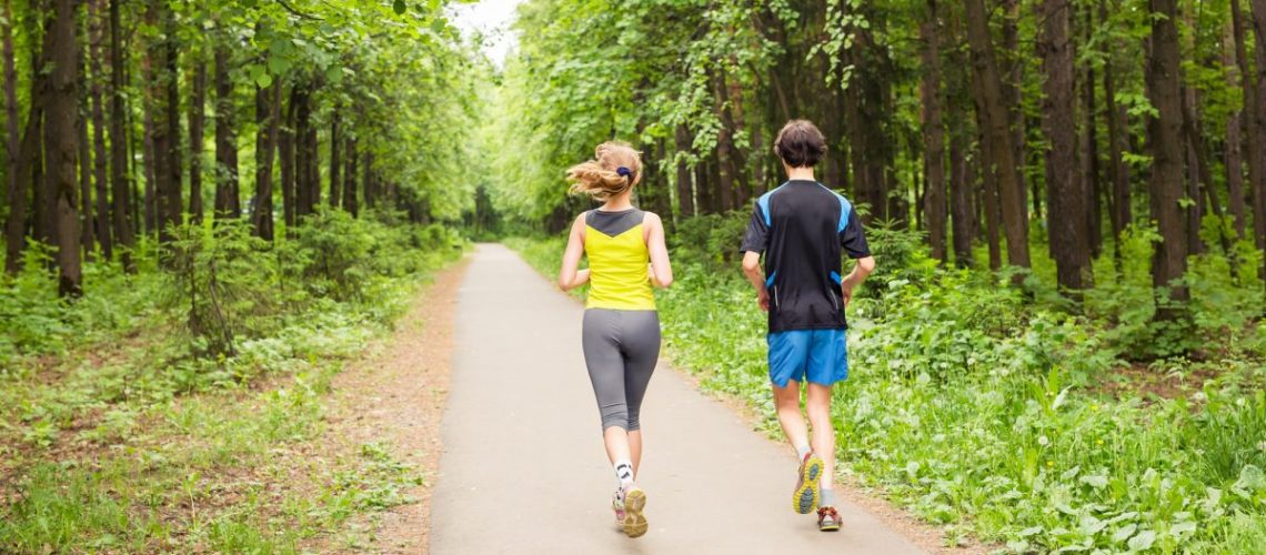 Running together - friends jogging in park