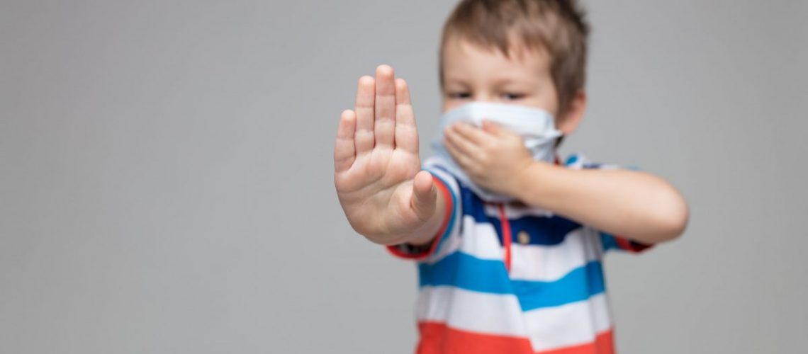 Young child wearing a respiratory mask as a prevention against the Coronavirus Covid-19